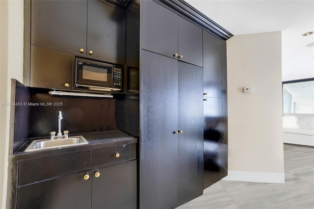 4000 Island Blvd Unit Ph6, Aventura, FL 33160 - kitchen with baseboards, black microwave, a sink, and dark countertops
