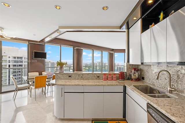 4000 Island Blvd Unit Ph6, Aventura, FL 33160 - kitchen with white cabinets, a peninsula, dishwasher, a sink, and backsplash
