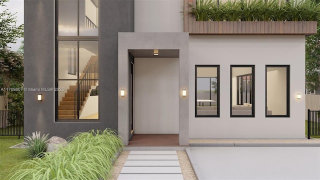 view of exterior entry with stucco siding and elevator
