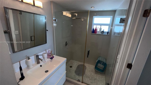 full bathroom featuring a shower stall and vanity