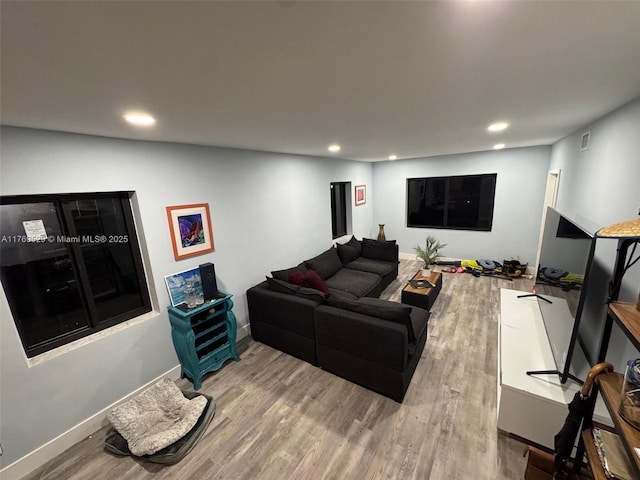 living room with recessed lighting, wood finished floors, and baseboards