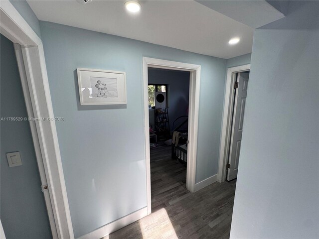 corridor featuring dark wood-style floors, baseboards, and recessed lighting