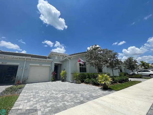 14531 Bretton Woods Trce, Delray Beach, FL 33446 - view of front of property with an attached garage, stucco siding, and decorative driveway