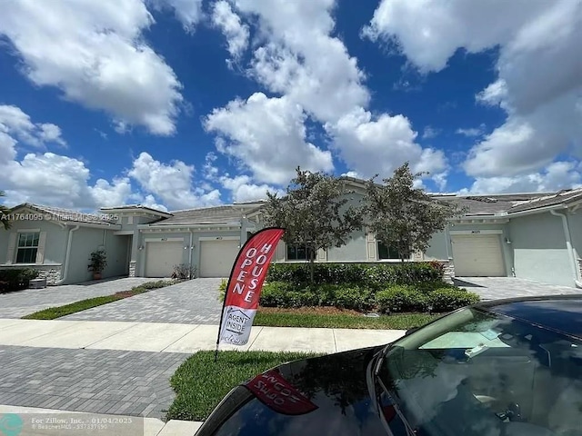 14531 Bretton Woods Trce, Delray Beach, FL 33446 - view of front of home with an attached garage, decorative driveway, and stucco siding
