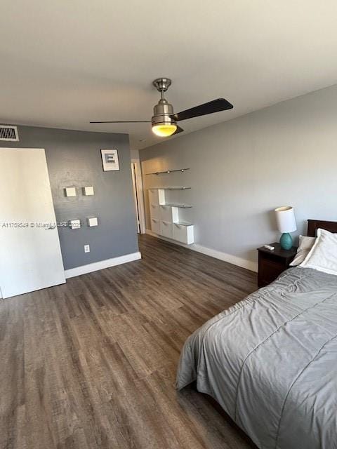 bedroom featuring baseboards, a ceiling fan, wood finished floors, and visible vents