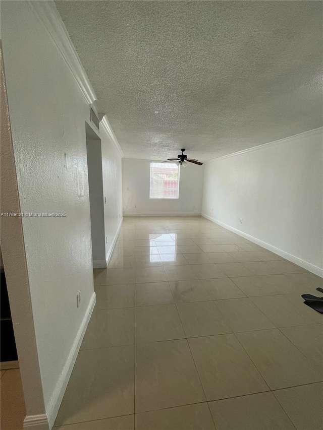 5775 W 20th Ave Unit 107, Hialeah, FL 33012 - empty room with ornamental molding, a textured ceiling, baseboards, a ceiling fan, and light tile patterned floors