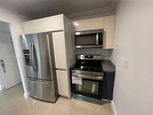 5775 W 20th Ave Unit 107, Hialeah, FL 33012 - kitchen featuring appliances with stainless steel finishes, crown molding, light tile patterned floors, and baseboards