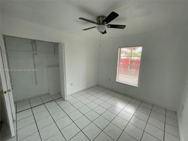 5775 W 20th Ave Unit 107, Hialeah, FL 33012 - unfurnished bedroom with a closet, light tile patterned floors, a ceiling fan, and a textured ceiling