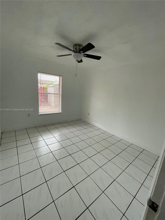 5775 W 20th Ave Unit 107, Hialeah, FL 33012 - spare room with a ceiling fan, light tile patterned floors, and a textured ceiling