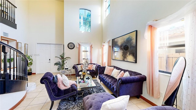 living room featuring stairs, visible vents, baseboards, and tile patterned floors