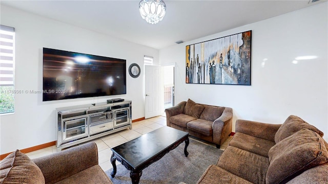 living room featuring baseboards, visible vents, and light tile patterned floors