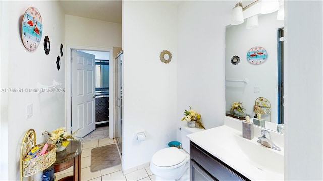 full bathroom featuring baseboards, toilet, tile patterned floors, vanity, and a stall shower