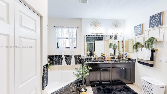 bathroom with tile patterned flooring, vanity, a garden tub, and a shower stall