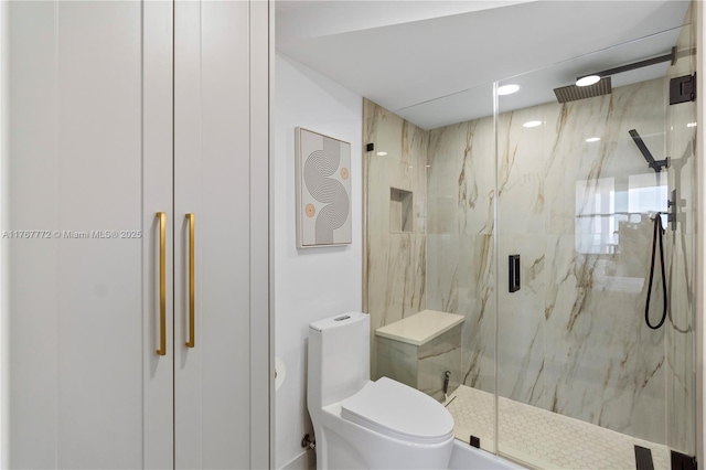 full bath with a marble finish shower and toilet