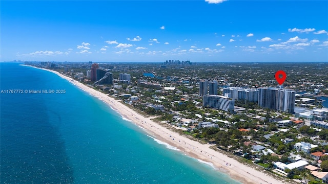 birds eye view of property with a water view, a view of the beach, and a city view