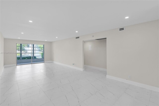 2501 Antigua Ter Unit F1, Coconut Creek, FL 33066 - empty room featuring light marble finish flooring, recessed lighting, and baseboards