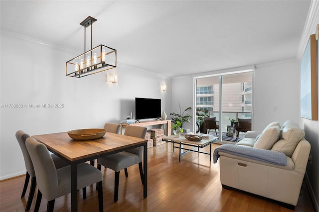2101 Brickell Ave Unit 1809, Miami, FL 33129 - dining area featuring wood-type flooring, ornamental molding, and a chandelier