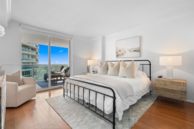 2101 Brickell Ave Unit 1809, Miami, FL 33129 - bedroom with access to outside, ornamental molding, wood finished floors, and a wall of windows