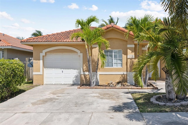 mediterranean / spanish-style home featuring stucco siding, driveway, a garage, and a tiled roof