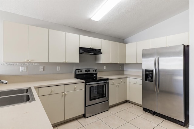 kitchen with light countertops, light tile patterned floors, stainless steel appliances, under cabinet range hood, and a sink