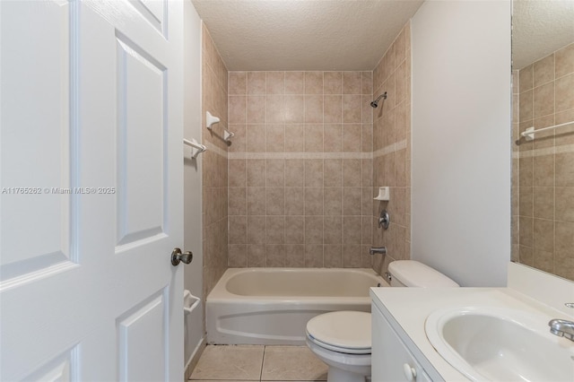 bathroom with toilet, vanity, washtub / shower combination, a textured ceiling, and tile patterned flooring