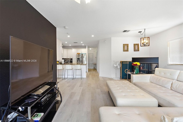 3340 Palomino Dr Unit 221-2, Davie, FL 33024 - living area featuring light wood finished floors, a chandelier, and recessed lighting