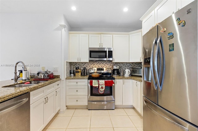 3340 Palomino Dr Unit 221-2, Davie, FL 33024 - kitchen with appliances with stainless steel finishes, a sink, light tile patterned floors, backsplash, and light stone counters