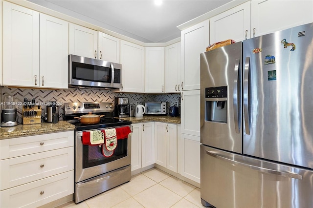 3340 Palomino Dr Unit 221-2, Davie, FL 33024 - kitchen featuring stainless steel appliances, light tile patterned flooring, decorative backsplash, stone countertops, and white cabinets