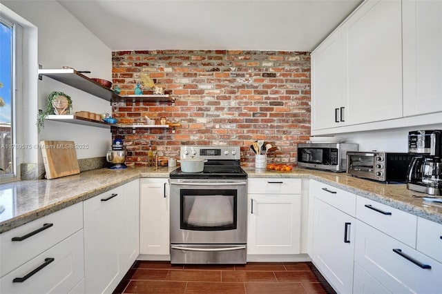 3407 N Longfellow Cir, Hollywood, FL 33021 - kitchen featuring appliances with stainless steel finishes, open shelves, white cabinetry, light stone countertops, and brick wall