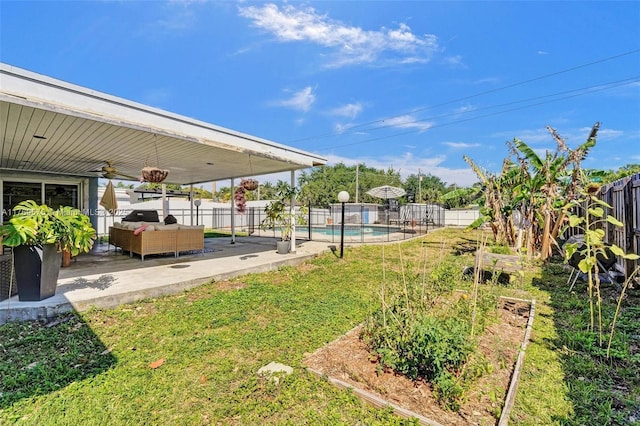 3407 N Longfellow Cir, Hollywood, FL 33021 - fenced backyard with a patio area, ceiling fan, a vegetable garden, and an outdoor hangout area