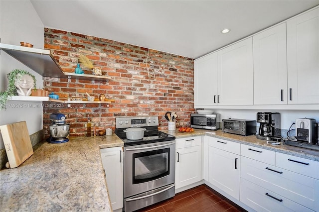3407 N Longfellow Cir, Hollywood, FL 33021 - kitchen featuring appliances with stainless steel finishes, open shelves, white cabinetry, dark wood-style floors, and brick wall