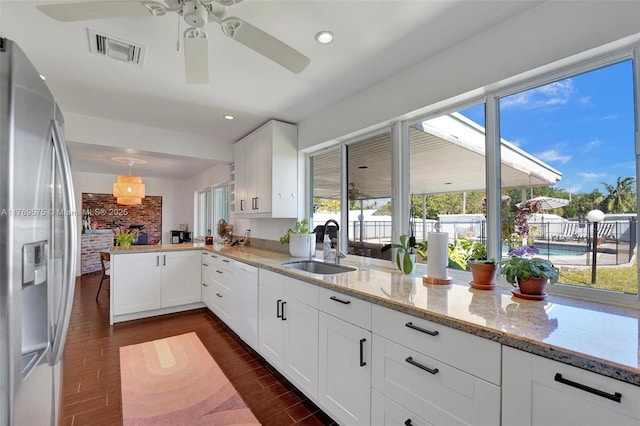 3407 N Longfellow Cir, Hollywood, FL 33021 - kitchen with stainless steel fridge with ice dispenser, a sink, a ceiling fan, dark wood finished floors, and white cabinetry