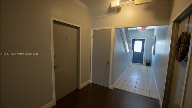 hallway with baseboards and wood finished floors
