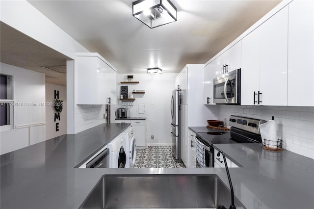 9137 Limetree Ln Unit 166, Pembroke Pines, FL 33024 - kitchen with appliances with stainless steel finishes, dark countertops, and white cabinets