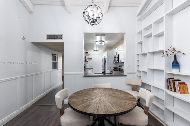 9137 Limetree Ln Unit 166, Pembroke Pines, FL 33024 - dining space with wood finished floors, beamed ceiling, built in features, a chandelier, and a high ceiling