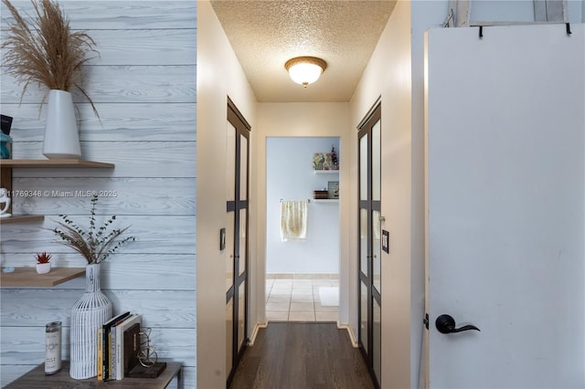 9137 Limetree Ln Unit 166, Pembroke Pines, FL 33024 - hall featuring a textured ceiling, dark wood-style flooring, and french doors