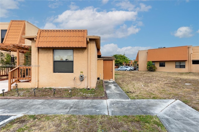 9137 Limetree Ln Unit 166, Pembroke Pines, FL 33024 - view of front facade featuring a tiled roof, stucco siding, and a pergola
