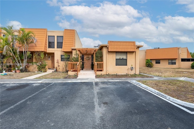 9137 Limetree Ln Unit 166, Pembroke Pines, FL 33024 - view of property with uncovered parking, stucco siding, and a tiled roof
