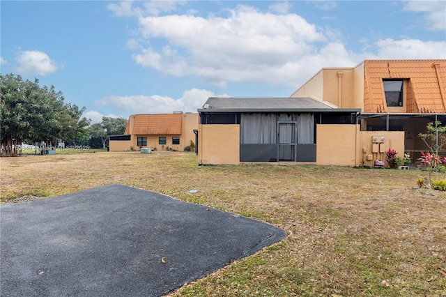 9137 Limetree Ln Unit 166, Pembroke Pines, FL 33024 - back of house featuring a yard and a tile roof
