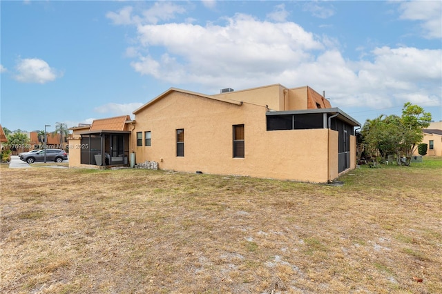 9137 Limetree Ln Unit 166, Pembroke Pines, FL 33024 - back of house with a sunroom, stucco siding, and a yard