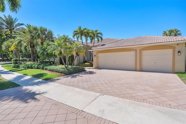 2541 Golf View Dr, Weston, FL 33327 - view of front of house featuring stucco siding, decorative driveway, a tiled roof, and a garage