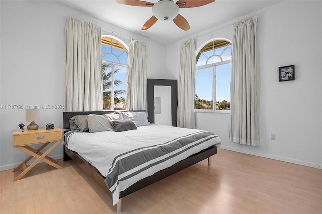 2541 Golf View Dr, Weston, FL 33327 - bedroom featuring multiple windows, light wood-type flooring, ceiling fan, and baseboards