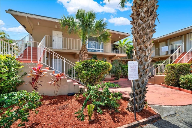 2864 NE 32nd St Unit 7, Fort Lauderdale, FL 33306 - view of front facade featuring stucco siding and stairway