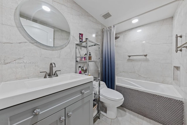 full bath with toilet, vanity, marble finish floor, visible vents, and tiled shower / bath