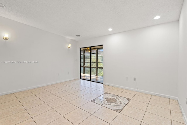 915 NE 199th St Unit 202-15, Miami, FL 33179 - spare room featuring recessed lighting, light tile patterned flooring, baseboards, and a textured ceiling