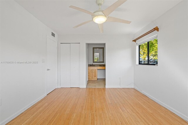915 NE 199th St Unit 202-15, Miami, FL 33179 - empty room with hardwood / wood-style floors, baseboards, visible vents, and a ceiling fan