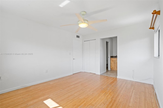 915 NE 199th St Unit 202-15, Miami, FL 33179 - spare room featuring baseboards, visible vents, ceiling fan, and light wood-style flooring