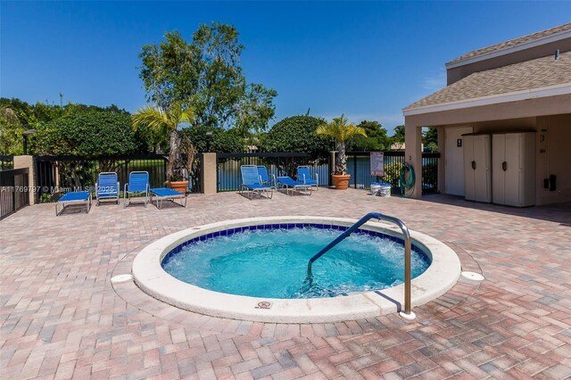 4306 N Carambola Cir N, Coconut Creek, FL 33066 - view of swimming pool featuring a hot tub, fence, and a patio