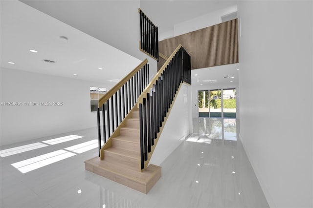 1170 Chenille Cir, Weston, FL 33327 - stairs featuring tile patterned flooring, recessed lighting, and a towering ceiling