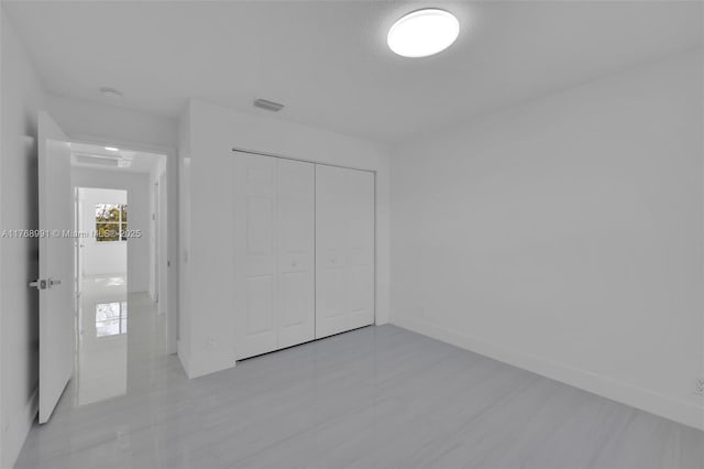 1170 Chenille Cir, Weston, FL 33327 - unfurnished bedroom featuring a closet and baseboards
